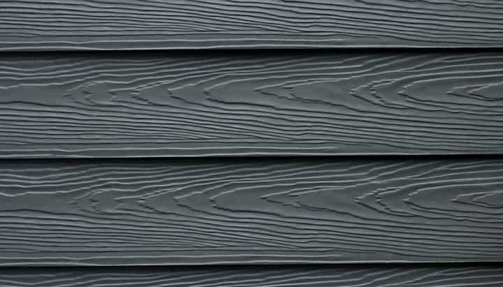 Beautiful grey fiber cement siding with natural looking wood grain installed on an older home.